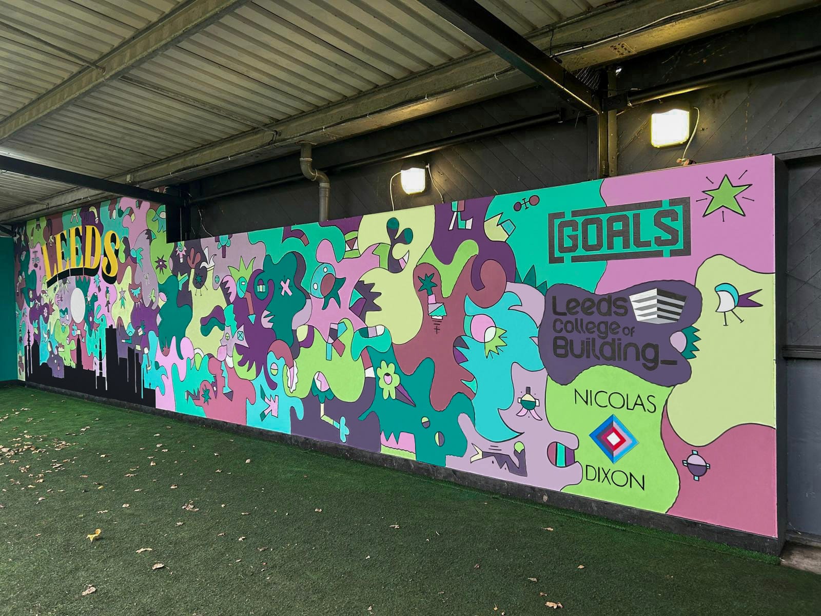 Business partnership tackles striking football mural